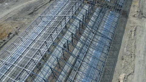 Flight over construction of a large metal structure in an agricultural area Stock-Footage 306300489