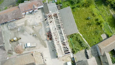 Flight over a construction site in small village Stock Footage 137024196