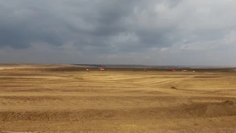 Flight over a construction site on which land management equipment works against Stock Footage 119869369