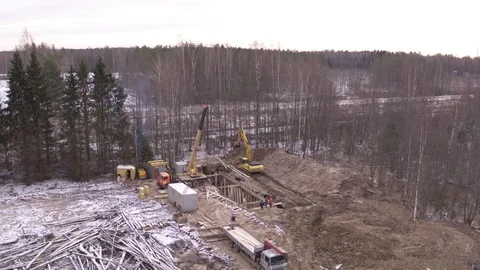 Flight over construction in winter forest Видео 123769844