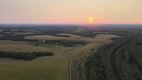 Flight over the countryside, fields, meadows and forests, setting Sun Stock Footage 254084156