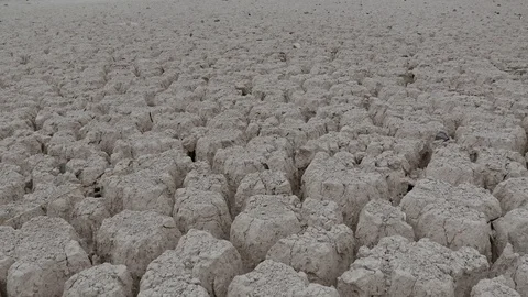 Flight over Cracked ground of the ocean dried because of Ecological Disaster Stock Footage 112371378