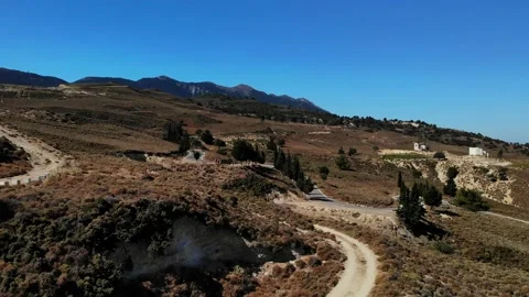 Flight over cury road in mountains with quad driving up Stock Footage 138005460