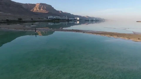 Flight over the dead sea. salt, water and dried shrubs. dead sea. Israel. Stockbeeldmateriaal 83859568