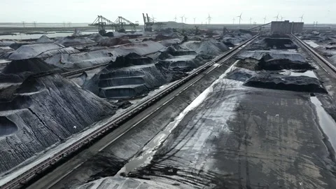 Flight over decommissioned coal power plant and wind turbines in distance Stock Footage 276237069