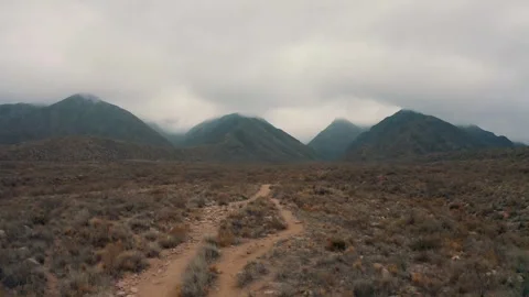 Flight over desert and mountains area in cloudy day Stock Footage 248842809