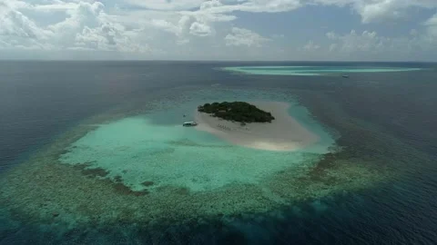 Flight over a desert island. A small island in the middle of the ocean. Video stock 150661679