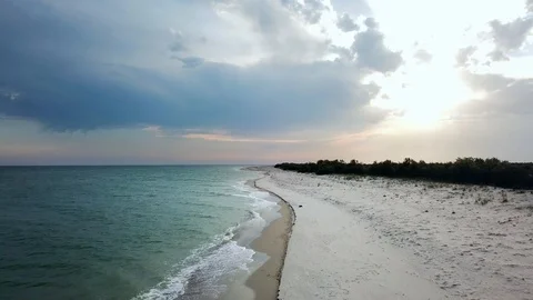 Flight over a deserted sandy beach by the sea Stock Footage 120647514
