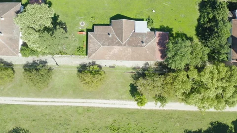 Flight over a dirt road in a small village on a sunny day Stock Footage 137801401