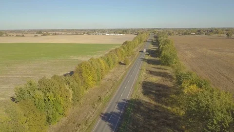 Flight over dirt road through farm fields, aerial video 動画素材 96312101