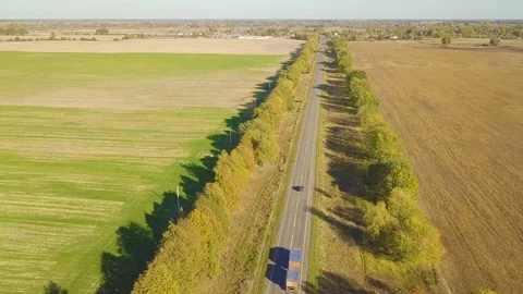Flight over dirt road through farm fields, aerial video 動画素材 96312244