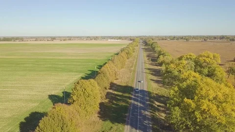 Flight over dirt road through farm fields, aerial video 動画素材 96312539