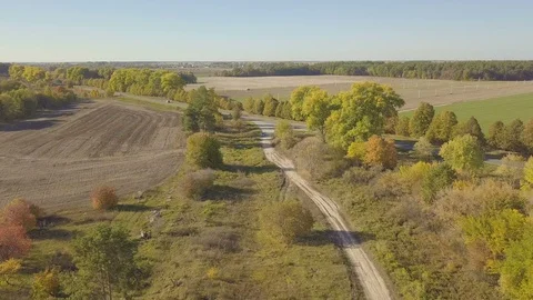 Flight over dirt road through farm fields, aerial video 動画素材 96312627