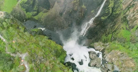 Flight over dramatic Vøringsfossen waterfall plunging down narrow canyon; Stock Footage 202065610