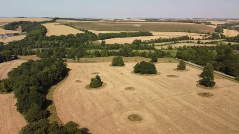 Flight over dry harvested fields in Wiltshire.  High summer Stockbeeldmateriaal 339497098