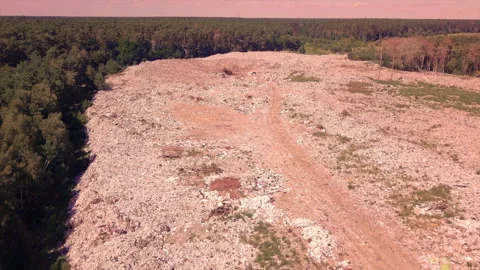 Flight over the dump around the forest, with mountains of household garbage Stock Footage 138355815