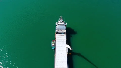 Flight over the empty bulk carrier with two large heavy-lift cranes. Dry cargo Stock Footage 334932321