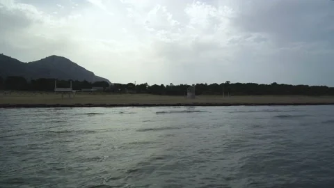Flight over empty calm beach, ocean waves hitting shore, drone parallax Stock Footage 132020437