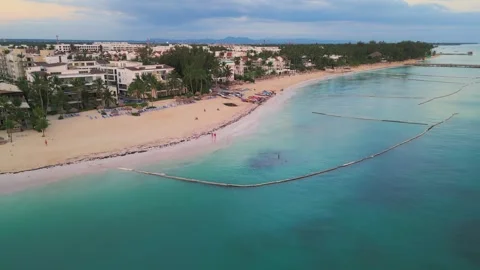 Flight over an empty tourist beach at a gentle sunrise in Punta Cana Stock Footage 306384858