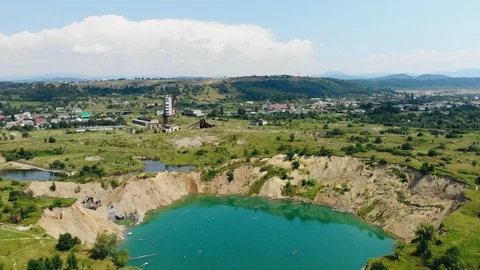 Flight over a failure in the ground which is filled with water. 4k. Stock Footage 94945485
