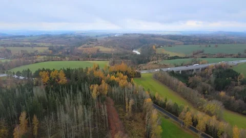 Flight over a field and forest next to a highway. Stock Footage 294386047