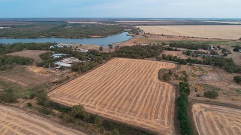 Flight over the field and the river through the buildings Stock Footage 111000152