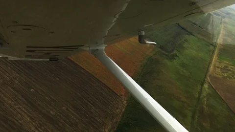 Flight over field view from cockpit plane. Stockbeeldmateriaal 94511733