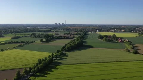 Flight over fields with a power plant in the background in Hamm, Germany 스톡 동영상 134494697