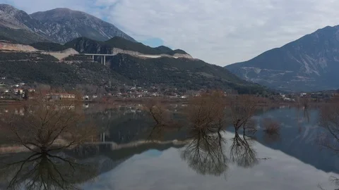 Flight over the flooded valley in Greece. The flooded fields, roads, mountains Stock Footage 127068270