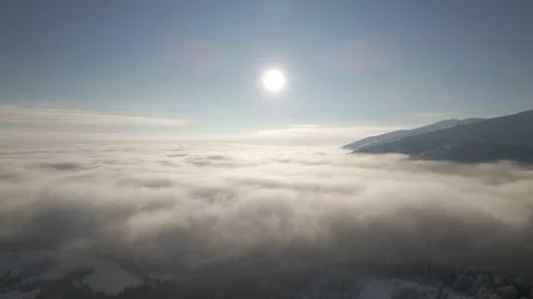Flight over the fog between the mountains. Clouds during beautiful morning Stock Footage 148299868