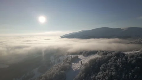 Flight over the fog between the mountains. Clouds during beautiful morning Stock Footage 148299953