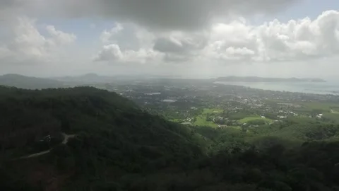 Flight over the forest, over the hill overlooks the village and the sea shor Stock Footage 131340477
