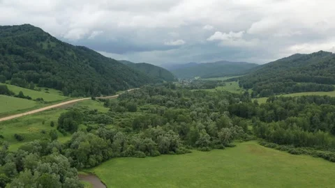 Flight over forests and dirt roads. Mountain landscape Stock Footage 249400690