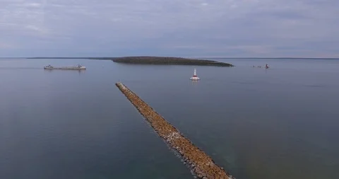 Flight over Freighter and Lighthouse on Mackinac Island Stock Footage 112805834