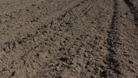 Flight over the freshly plowed earth 4K aerial video Stock Footage 105305142