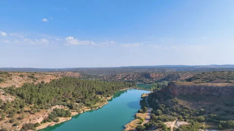 Flight over the green blue spring fed lagoons and forest of Ruidera in Spain's Stock Footage 344906963