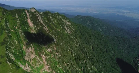 Flight over green forest and mountain range in light mist. Stock Footage 127098828