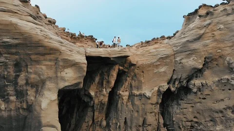 Flight over a high rock cliff, revealing a overview of the sea and the sky Stock Footage 103374009