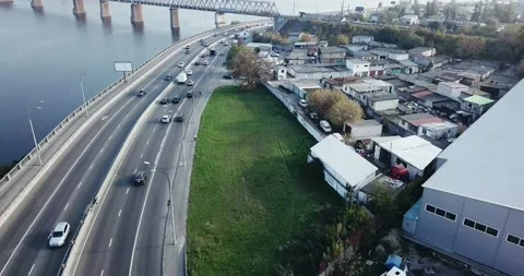 Flight over the highway, along the river and the industrial zone on the other Stock Footage 145953613