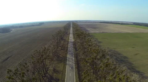 Flight over the highway between the fields outside the city Stock Footage 61197838