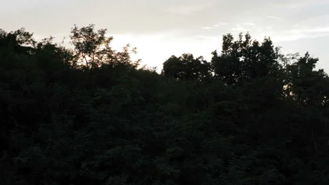A flight over a hill and discovering a beautiful sunset 库存影片 138025254
