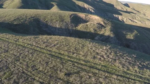 Flight over a hill in the sun Stock Footage 91400287