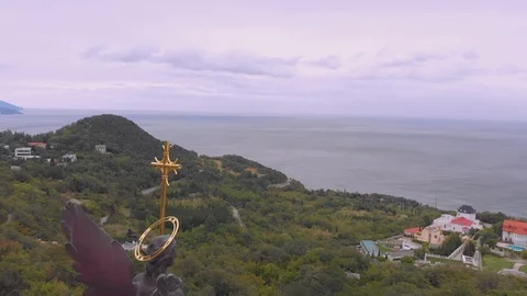 Flight over hilly seacoast with small town under grey sky 스톡 동영상 103282864