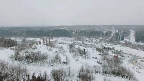 Flight over industrial and construction site surrounded by forest Stock Footage 92853824