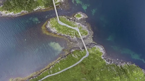 Flight over islands with dense greenery, in the middle of blue sea in Norway Stock Footage 80250917