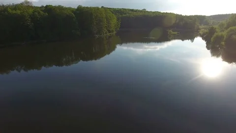 Flight over the lake and forest in the early morning. Aerial Drone Footage Stock Footage 75660744