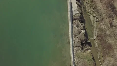 Flight over lake border and dam top 4k Stock Footage 148571443