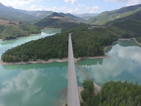 Flight over the lake bridge with clouds reflection in the water Stock Footage 72168055