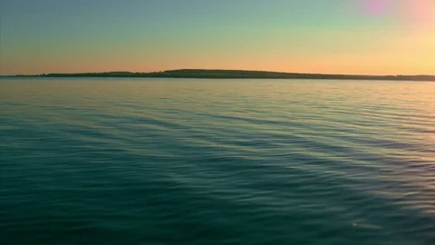Flight over the lake during sunset Stock Footage 79387859