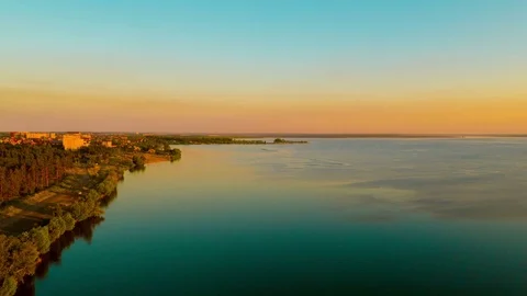 Flight over the lake during sunset Stock Footage 79388361